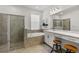 Bright main bathroom featuring tile floors, walk in shower, bath tub, double vanity, makeup station at 5637 Beggs Road, St Cloud, FL 34771