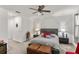 Spacious main bedroom suite boasts decorative pillows and lamps and neutral color scheme with fan at 5637 Beggs Road, St Cloud, FL 34771