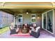 Cozy covered patio with brick flooring, comfortable seating, and an outdoor ceiling fan for relaxing gatherings at 5637 Beggs Road, St Cloud, FL 34771