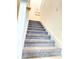 Carpeted stairway leading to the upper level of the home at 5637 Beggs Road, St Cloud, FL 34771