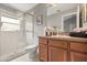Bathroom showcasing a glass-enclosed shower, a toilet, a vanity with a sink, and a mirror at 650 Old Bridge Cir, Davenport, FL 33897