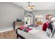 Bedroom with a bed, a dresser with a TV, and a view of the outdoor area, creating a relaxing atmosphere at 650 Old Bridge Cir, Davenport, FL 33897