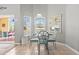 Charming dining area with a glass table, decorative chairs, and natural light overlooking the pool at 650 Old Bridge Cir, Davenport, FL 33897