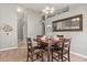 Dining area with a wood table, neutral paint, and seamless flow into the adjacent living spaces at 650 Old Bridge Cir, Davenport, FL 33897