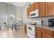 Bright kitchen with white appliances and a cozy dining nook overlooking the backyard at 650 Old Bridge Cir, Davenport, FL 33897