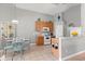 Cozy eat-in kitchen with light wood cabinets, white appliances, and ample counter space at 650 Old Bridge Cir, Davenport, FL 33897