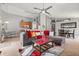 Open-concept living room with a gray sofa, a ceiling fan, and access to the kitchen and dining area at 650 Old Bridge Cir, Davenport, FL 33897