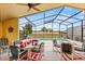 Inviting screened patio featuring a dining area with a pool view, perfect for outdoor entertaining and relaxation at 650 Old Bridge Cir, Davenport, FL 33897