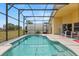 Enjoy the screened pool with a patio area for outdoor lounging and entertaining at 650 Old Bridge Cir, Davenport, FL 33897