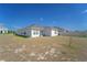 A home's backyard featuring a lawn, offering potential for outdoor activities and relaxation at 820 Overpool Ave, Davenport, FL 33896