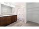 Bathroom with granite countertops, dual sinks, and an expansive vanity with a marble shower at 820 Overpool Ave, Davenport, FL 33896