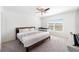 Bright bedroom with ceiling fan and natural light, includes crib for a baby at 820 Overpool Ave, Davenport, FL 33896