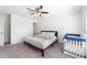 Bright bedroom with ceiling fan and natural light, includes crib for a baby at 820 Overpool Ave, Davenport, FL 33896