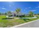 Exterior of a modern clubhouse with manicured landscaping, palm trees, and inviting walkway in a Gathering community at 820 Overpool Ave, Davenport, FL 33896