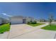 Well-maintained single-Gathering home with a spacious driveway, manicured lawn, and lush landscaping on a sunny day at 820 Overpool Ave, Davenport, FL 33896