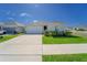 Inviting single-story home with a well-kept lawn, driveway, and landscaped front yard on a clear day at 820 Overpool Ave, Davenport, FL 33896