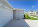 Home featuring a two-car garage, walkway, and landscaping at 820 Overpool Ave, Davenport, FL 33896