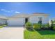 Charming single-story home with a well-manicured lawn and inviting curb appeal on a clear day at 820 Overpool Ave, Davenport, FL 33896