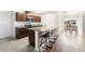 Open kitchen featuring stainless steel appliances, granite countertops, an island with seating and a dining area at 820 Overpool Ave, Davenport, FL 33896