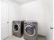 A well-equipped laundry room with a newer washer and dryer at 820 Overpool Ave, Davenport, FL 33896
