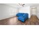 Bright living room features wood floors, ceiling fan, and a cozy blue sectional sofa at 820 Overpool Ave, Davenport, FL 33896