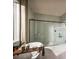 Modern bathroom with a soaking tub and a separate glass-enclosed shower at 9429 Golden Laurel Ln, Orlando, FL 32827