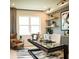 Inviting home office with a glass desk, accent wall, and natural light from a large window at 9429 Golden Laurel Ln, Orlando, FL 32827