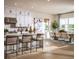 Bright, open-concept kitchen featuring white cabinetry, stainless steel appliances, and an adjacent dining area at 9429 Golden Laurel Ln, Orlando, FL 32827