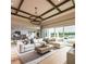 Bright living room featuring hardwood floors, stylish furniture, and large windows at 9429 Golden Laurel Ln, Orlando, FL 32827