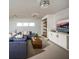 Cozy living room featuring a comfortable blue sofa, modern lighting, and built-in shelving at 9429 Golden Laurel Ln, Orlando, FL 32827