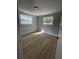 Bright bedroom boasts modern flooring and two windows for natural light at 969 Chestnut St, Clermont, FL 34711