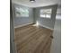 Comfortable bedroom featuring wood-look flooring and neutral paint at 969 Chestnut St, Clermont, FL 34711