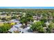 Aerial view of home in a neighborhood with mature trees and colorful homes at 4710 Hatteras Ct, Orlando, FL 32808
