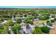 Aerial view of the neighborhood with mature trees and a pond nearby at 4710 Hatteras Ct, Orlando, FL 32808