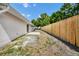 Spacious backyard with a new privacy fence and a small patio off the back of the house at 4710 Hatteras Ct, Orlando, FL 32808