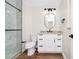 Modern bathroom featuring a granite countertop, a glass door shower and black hardware accents at 4710 Hatteras Ct, Orlando, FL 32808