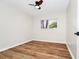Bedroom with neutral walls, wood-look flooring, ceiling fan, and window at 4710 Hatteras Ct, Orlando, FL 32808