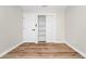Bedroom featuring wood-look flooring, a closet with built-in shelving, and neutral walls at 4710 Hatteras Ct, Orlando, FL 32808
