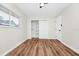 This bedroom features wood-look flooring, a ceiling fan, a window, and a closet at 4710 Hatteras Ct, Orlando, FL 32808