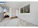 Inviting covered front porch with tiled walkway and access to the main door, and a large window at 4710 Hatteras Ct, Orlando, FL 32808