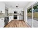 Modern kitchen featuring new stainless steel appliances, white cabinets, granite counters and sliding glass doors to the yard at 4710 Hatteras Ct, Orlando, FL 32808