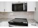 Kitchen boasts stainless steel microwave and glass cooktop at 4710 Hatteras Ct, Orlando, FL 32808