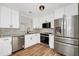 Remodeled kitchen featuring stainless steel appliances, granite countertops, modern fixtures, and wood flooring at 4710 Hatteras Ct, Orlando, FL 32808