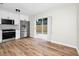 Modern kitchen featuring new stainless steel appliances, white cabinets, and sliding glass doors to the yard at 4710 Hatteras Ct, Orlando, FL 32808