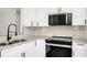 Updated kitchen with white cabinets, granite countertops, stainless steel appliances, and tile backsplash at 4710 Hatteras Ct, Orlando, FL 32808