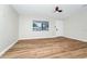 Bright living room featuring new wood floors, modern ceiling fan, fresh paint and natural light at 4710 Hatteras Ct, Orlando, FL 32808