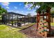 Wide shot of spacious backyard featuring a pool enclosure and play set, perfect for outdoor fun at 1026 Manchester Cir, Winter Park, FL 32792