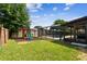 Spacious backyard featuring a play set, lush lawn, and a screened-in pool area at 1026 Manchester Cir, Winter Park, FL 32792
