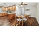 Eat-in kitchen featuring wooden cabinets, granite countertops, stainless appliances, and wood floors at 1026 Manchester Cir, Winter Park, FL 32792