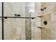 Beautiful glass enclosed shower featuring decorative stone accents, a rainfall shower head, and tiled walls at 1026 Manchester Cir, Winter Park, FL 32792